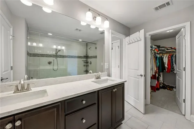 a bathroom with a sink double vanity and a shower