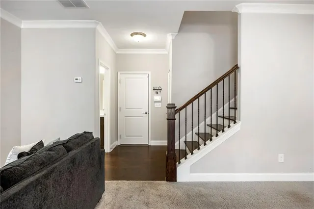 a living room with furniture and stairs