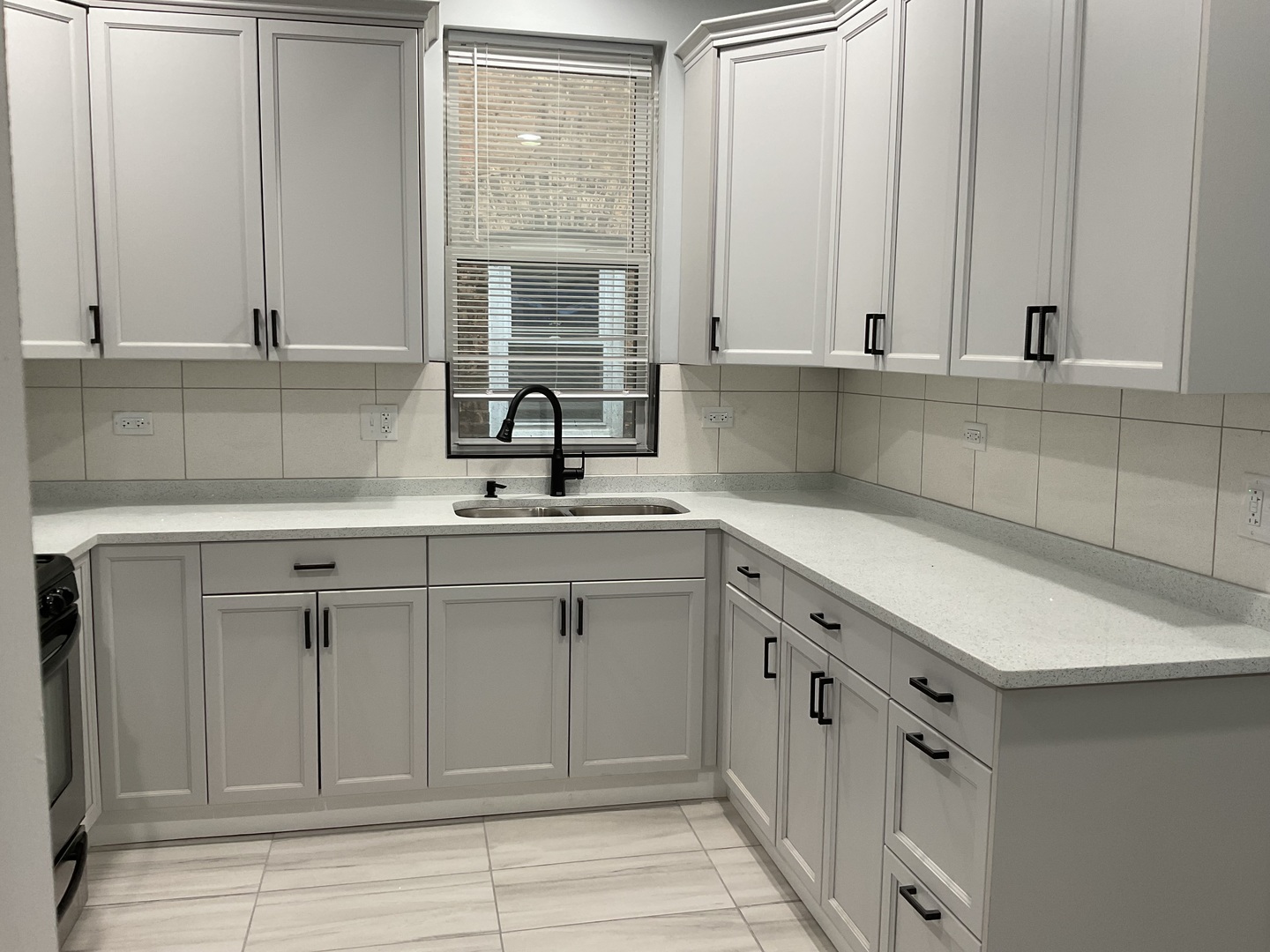 7940 South Carpenter Street, Unit 2 Chicago, IL 60620 - Photo 18 of 34 a kitchen with white cabinets and sink