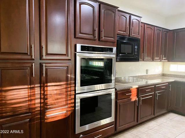 a kitchen with stainless steel appliances granite countertop a stove microwave and cabinets