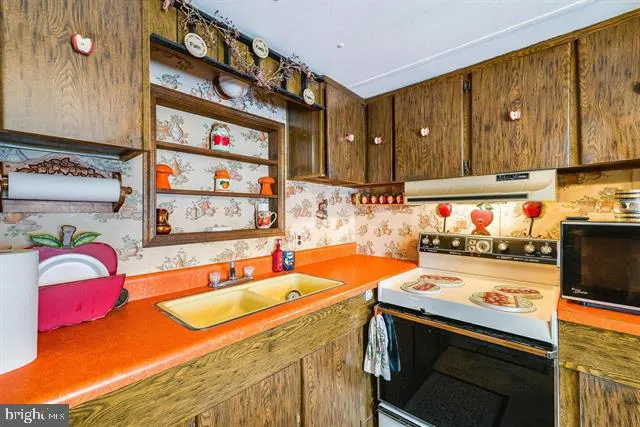 a kitchen with stainless steel appliances granite countertop a refrigerator and a stove