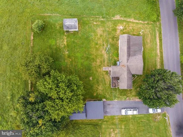 an aerial view of a residential houses with outdoor space and swimming pool