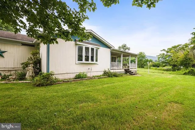 an aerial view of residential houses with outdoor space and lake view