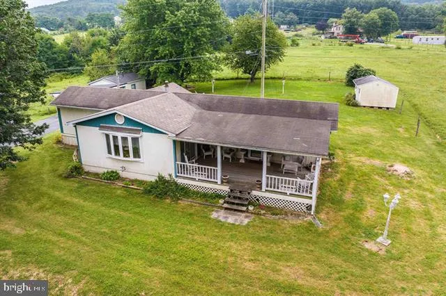 a aerial view of a house with swimming pool and a garden