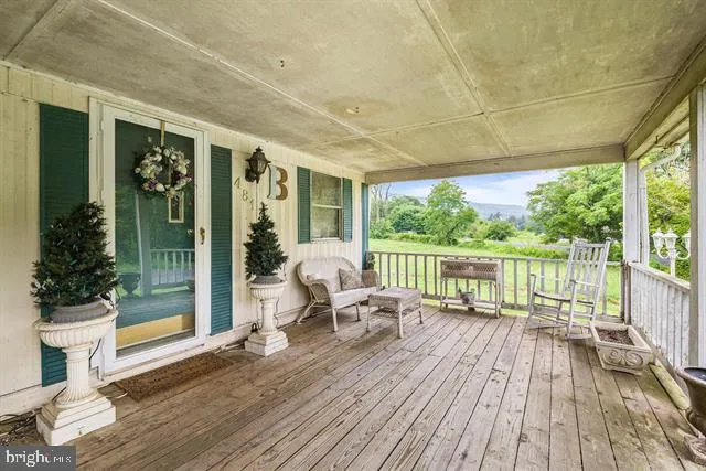 a balcony with furniture and wooden floor