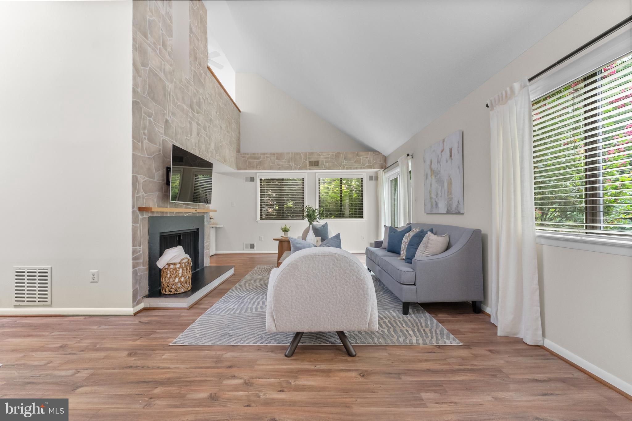 11303 Harborside Cluster Reston, VA 20191 - Photo 12 of 30 a living room with furniture a fireplace and a large window