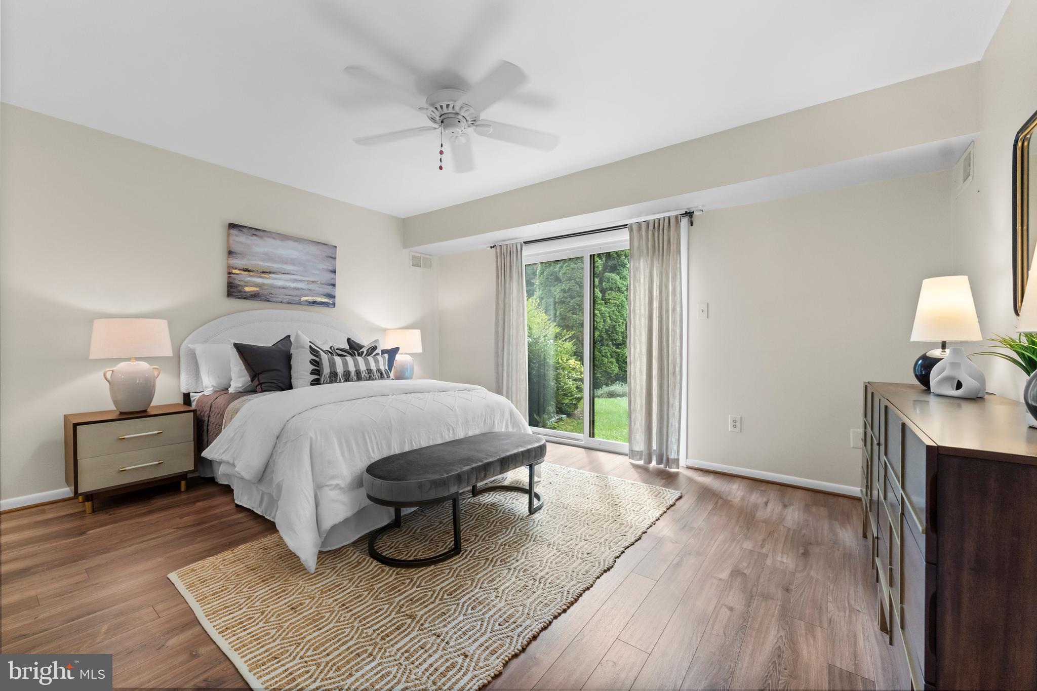 11303 Harborside Cluster Reston, VA 20191 - Photo 20 of 30 a spacious bedroom with a bed and wooden floor