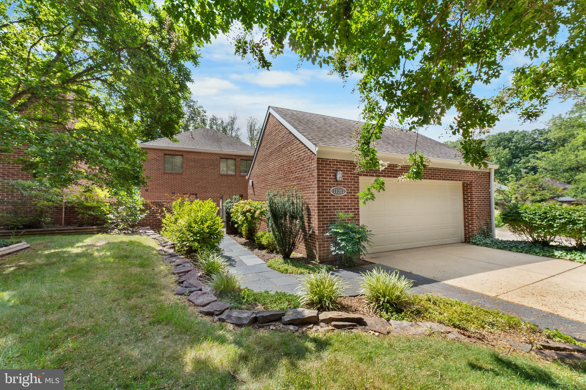 11303 Harborside Cluster Reston, VA 20191 - Photo 2 of 30 a front view of a house with a yard and a tree