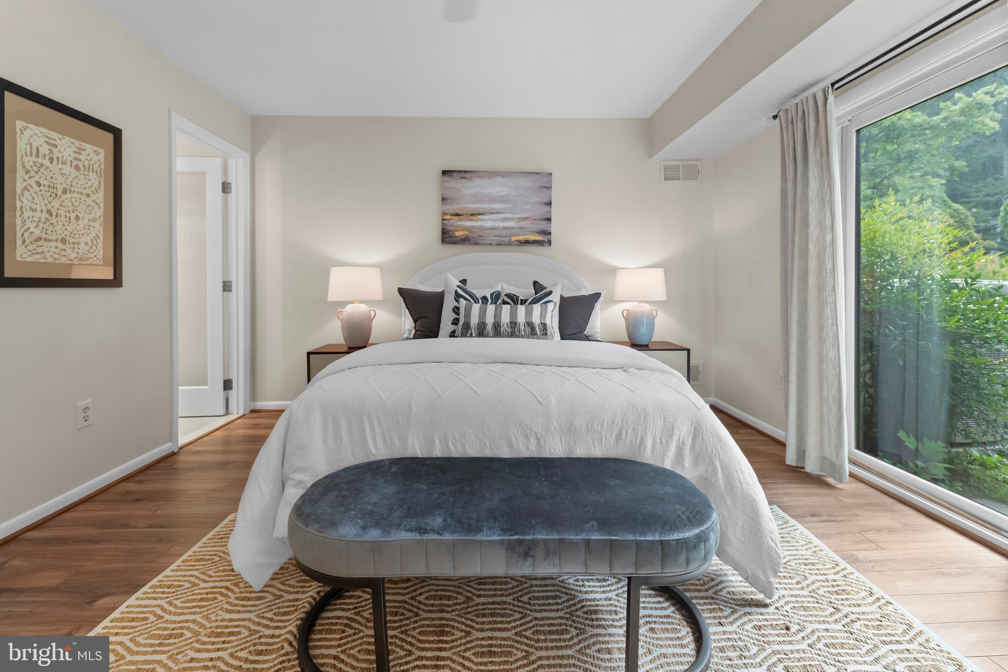 11303 Harborside Cluster Reston, VA 20191 - Photo 21 of 30 a bed sitting in a bedroom next to a window