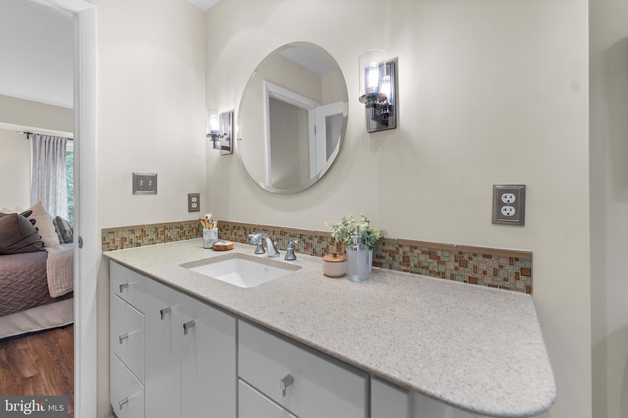 11303 Harborside Cluster Reston, VA 20191 - Photo 23 of 30 a bathroom with a sink and a mirror