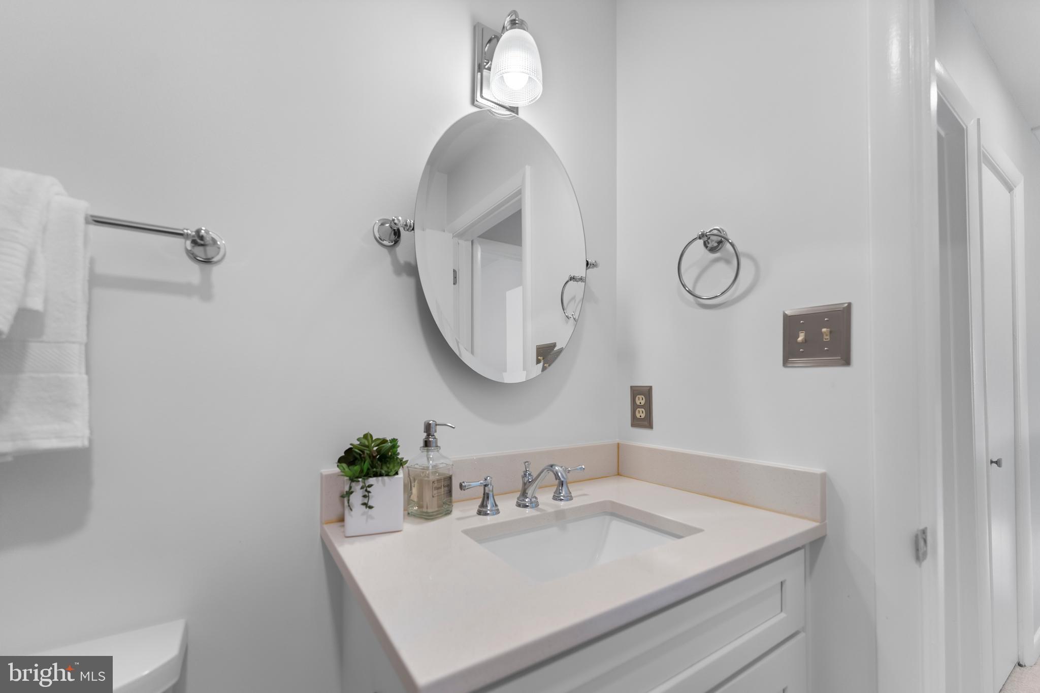 11303 Harborside Cluster Reston, VA 20191 - Photo 26 of 30 a bathroom with a sink vanity and a mirror