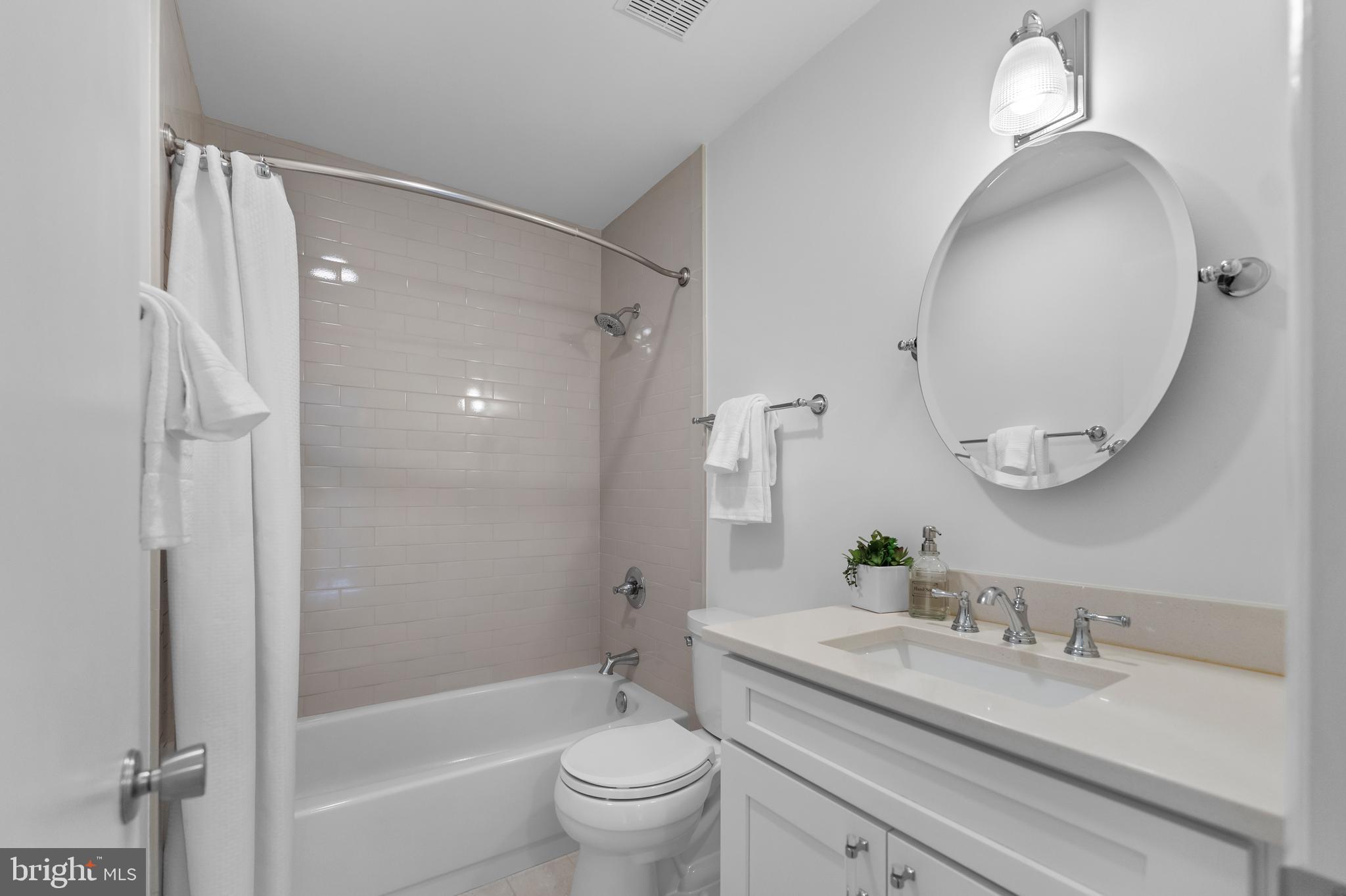 11303 Harborside Cluster Reston, VA 20191 - Photo 27 of 30 a bathroom with a granite countertop sink toilet and shower