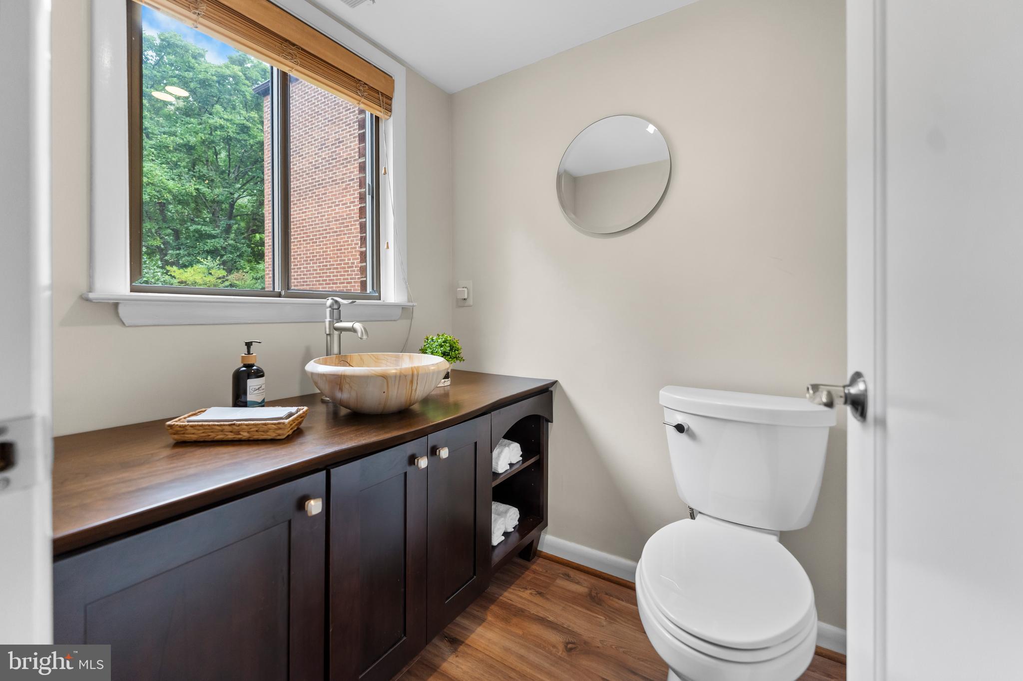 11303 Harborside Cluster Reston, VA 20191 - Photo 10 of 30 a bathroom with a granite countertop toilet sink and mirror