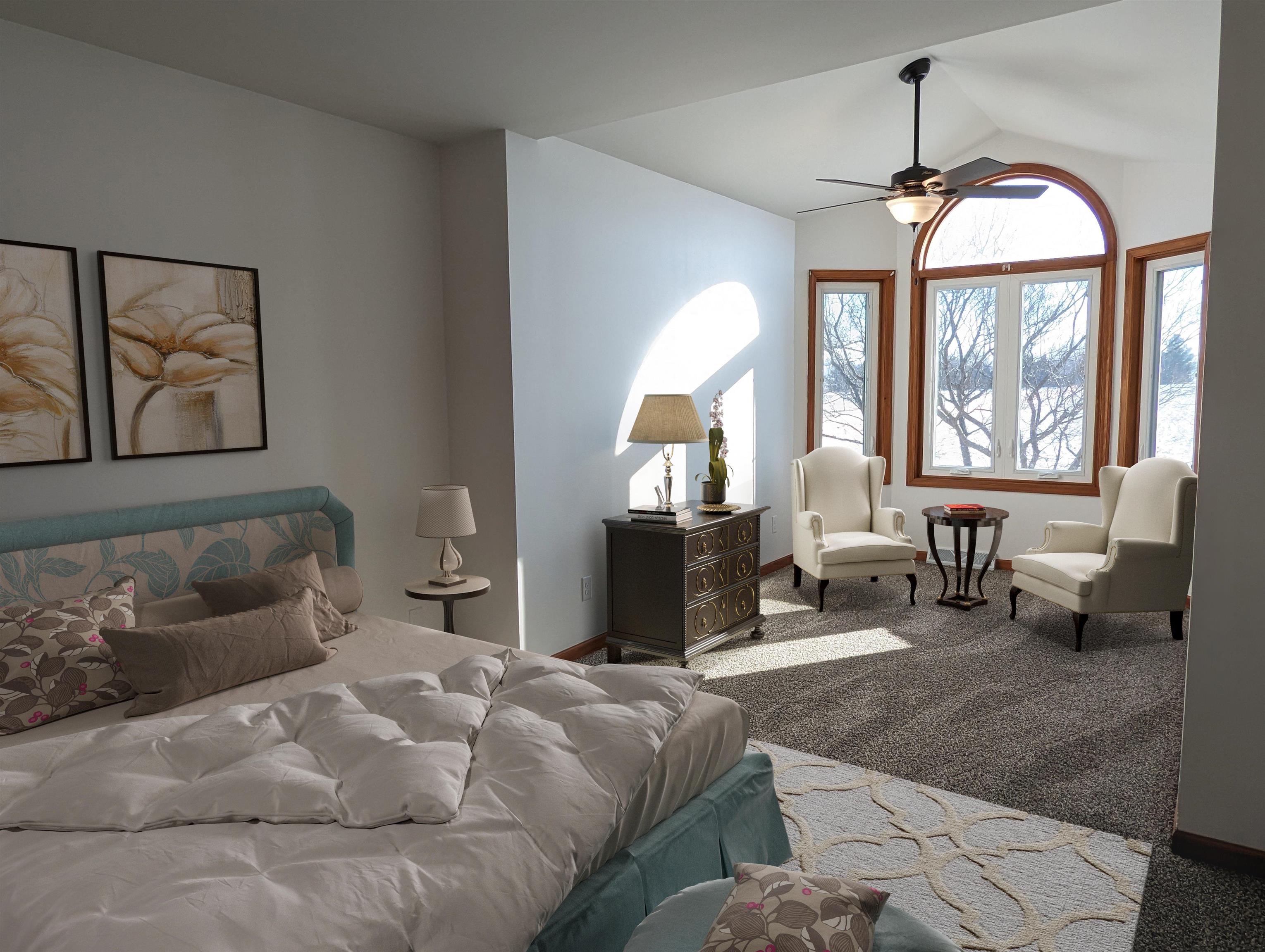 8712 East Kelley Road German Valley, IL 61039 - Photo 18 of 34 a spacious bedroom with a bed a couch and large windows