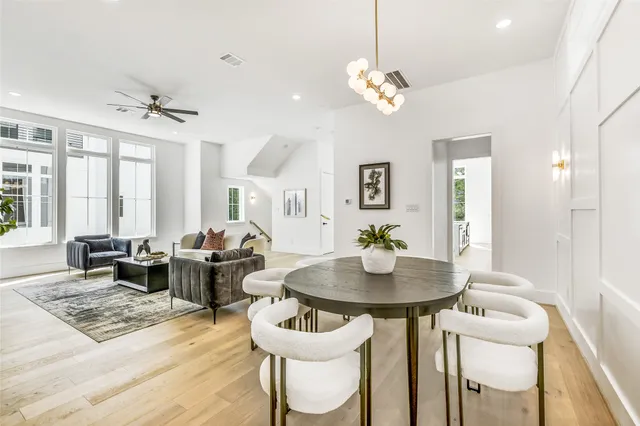 a kitchen with stainless steel appliances granite countertop a stove a sink and a wooden floors