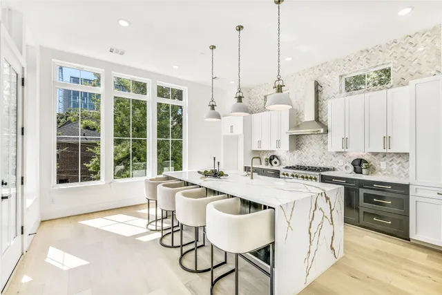 a kitchen with a stove and white cabinets