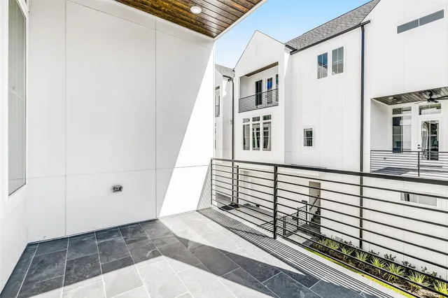 a spacious bedroom with a large bed and a chandelier
