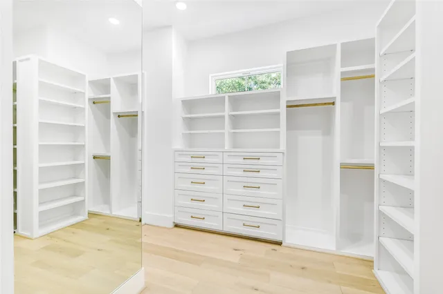 a kitchen with stainless steel appliances white cabinets and a sink