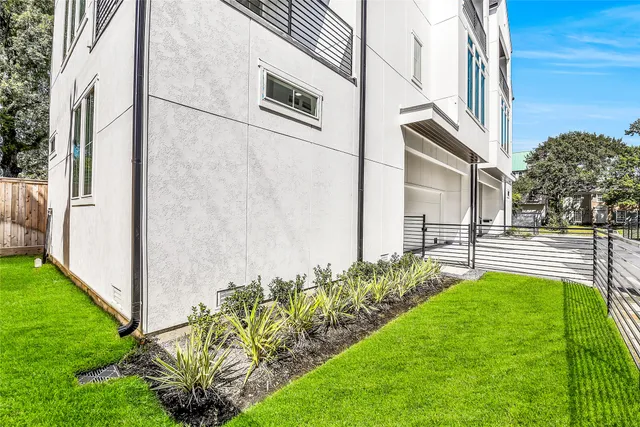 a view of an house with backyard and sitting area