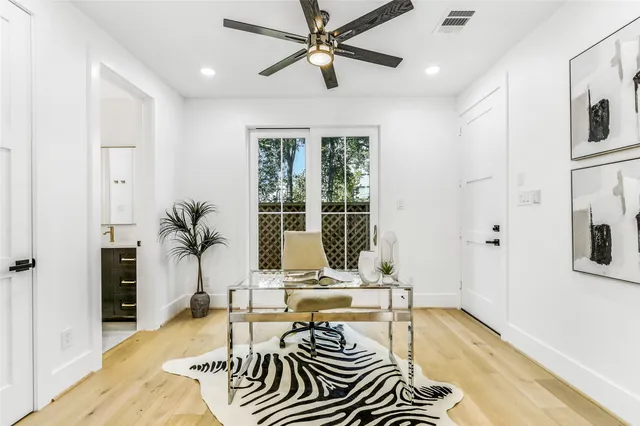 a living room with furniture a fireplace and a chandelier