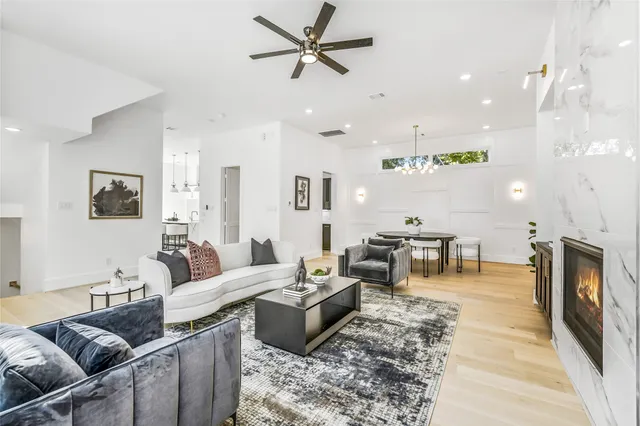 a view of a dining room with furniture a chandelier and wooden floor