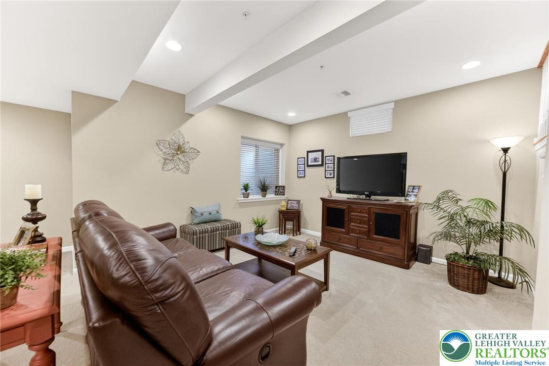 5440 Spring Ridge Drive West Macungie, PA 18062 - Photo 31 of 40 Well-lit living room offers plush carpet, recessed lighting, and a large window.