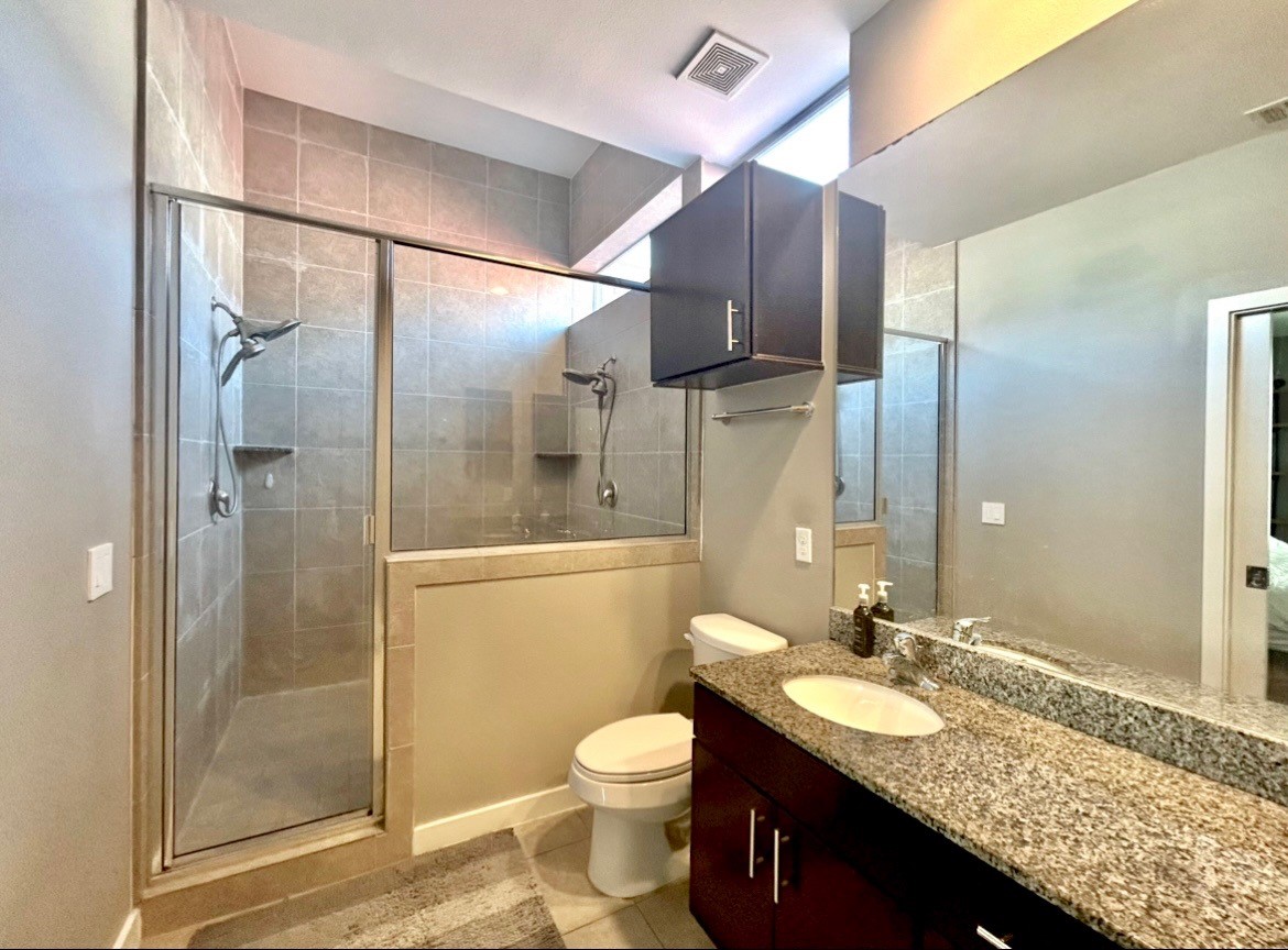 3010 Commerce Street Houston, TX 77003 - Photo 6 of 10 a bathroom with a granite countertop sink toilet and shower