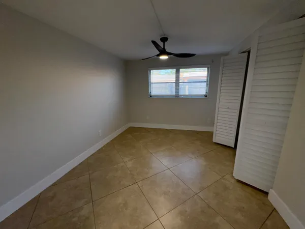 an empty room with windows and entrance