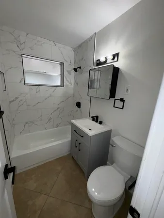 a view of an empty room and chandelier fan