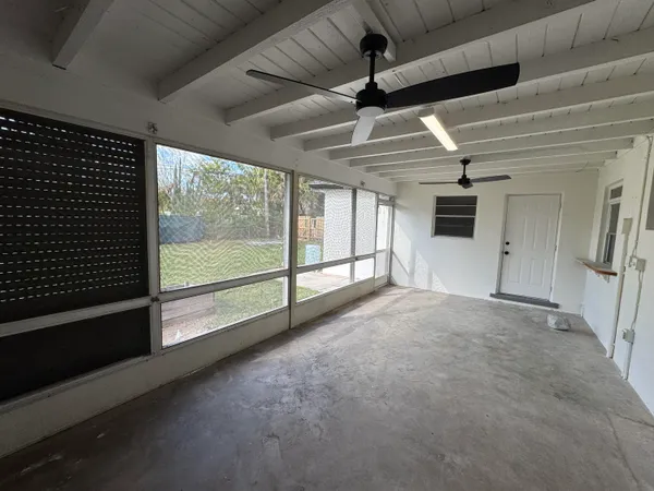 a front view of a house with garden and trees