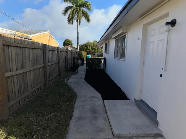 a view of a palm tree with flower plants