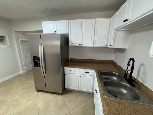 a kitchen with cabinets and stainless steel appliances