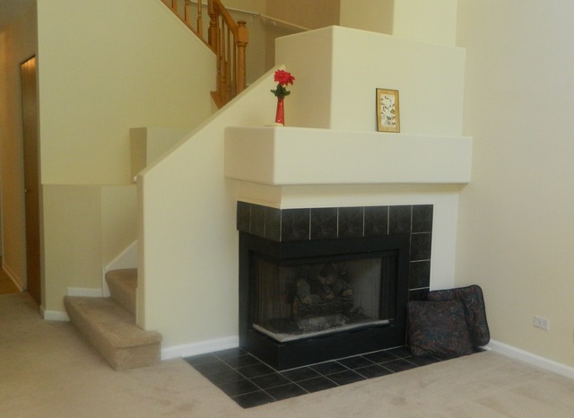 881 Brompton Court Carol Stream, IL 60188 - Photo 3 of 19 a fireplace with a clock on wall