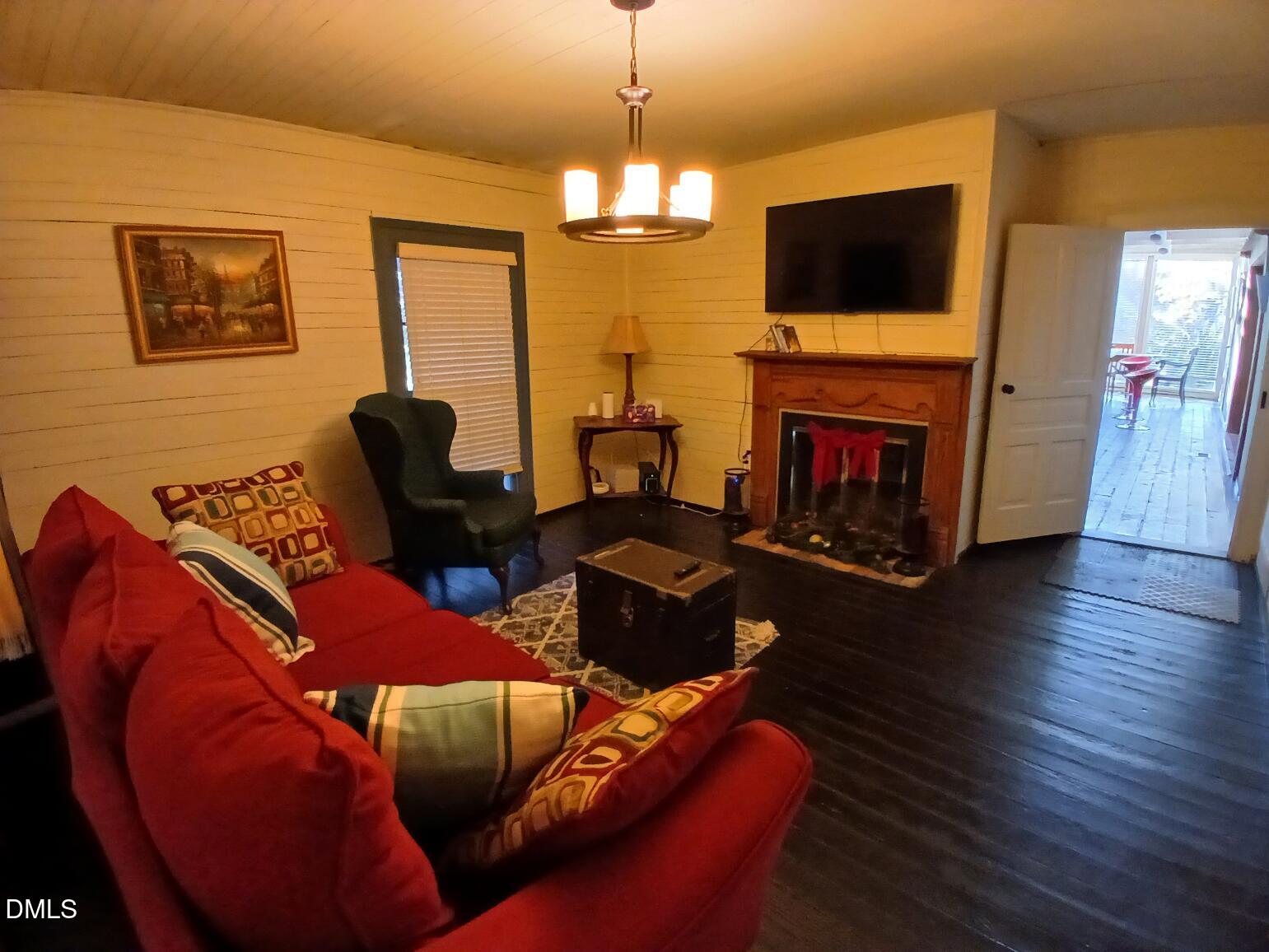 1920 Kelly Road Apex, NC 27502 - Photo 30 of 44 a living room with furniture a flat screen tv and a fireplace