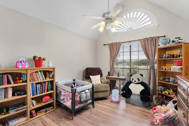 a bedroom with furniture book shelf and a window