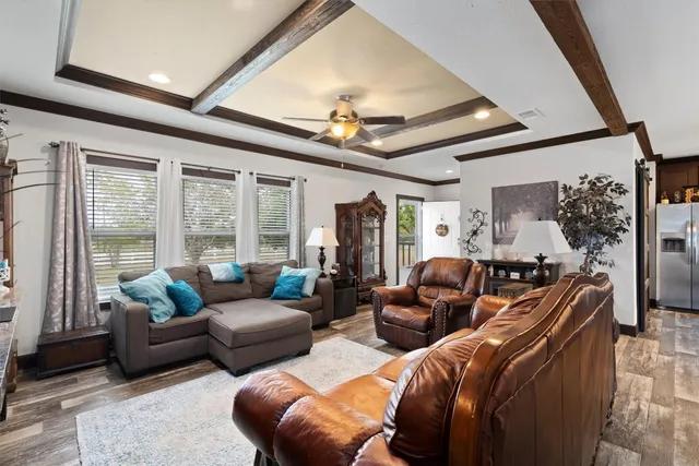a living room with furniture ceiling fan and a rug