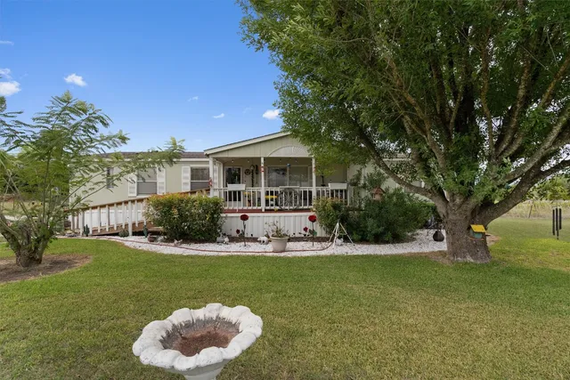 a view of house with a yard in front of house