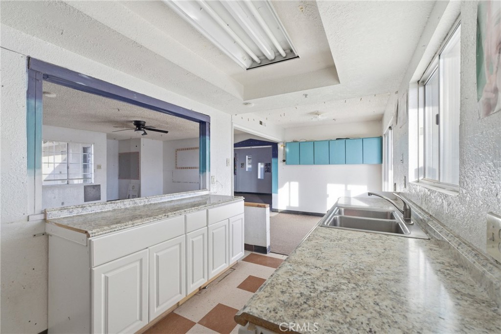 15637 Tuscola Road Apple Valley, CA 92307 - Photo 11 of 57 a bathroom with a sink a large mirror and a shower
