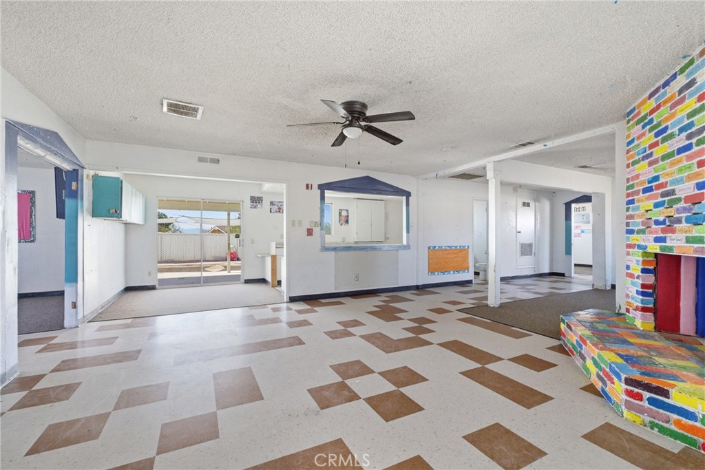 15637 Tuscola Road Apple Valley, CA 92307 - Photo 14 of 57 a living room with furniture and a book shelf