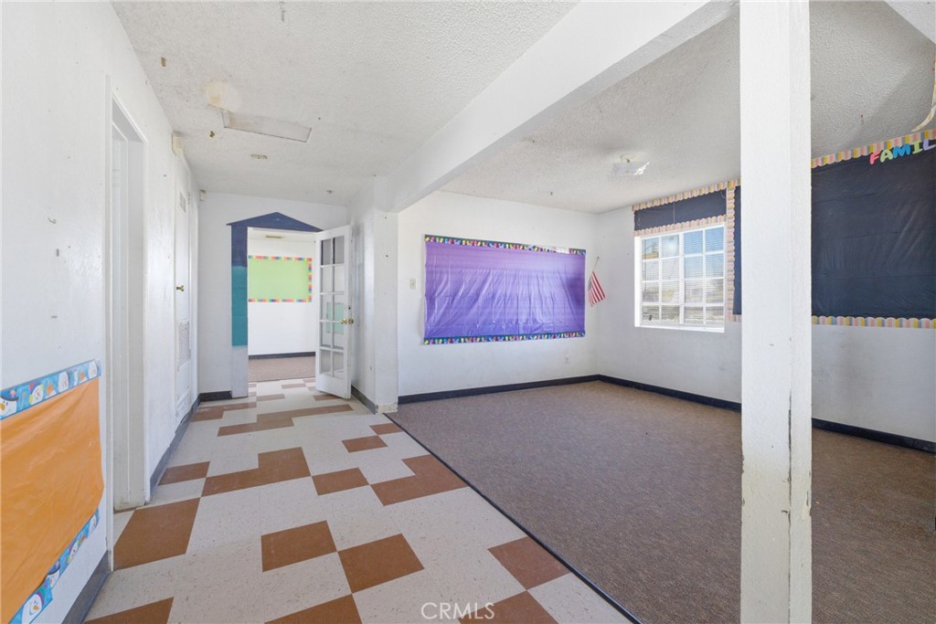 15637 Tuscola Road Apple Valley, CA 92307 - Photo 20 of 57 a view of a big room with windows and chandelier