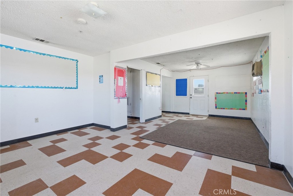 15637 Tuscola Road Apple Valley, CA 92307 - Photo 22 of 57 a view of a livingroom with wooden floor and a rug
