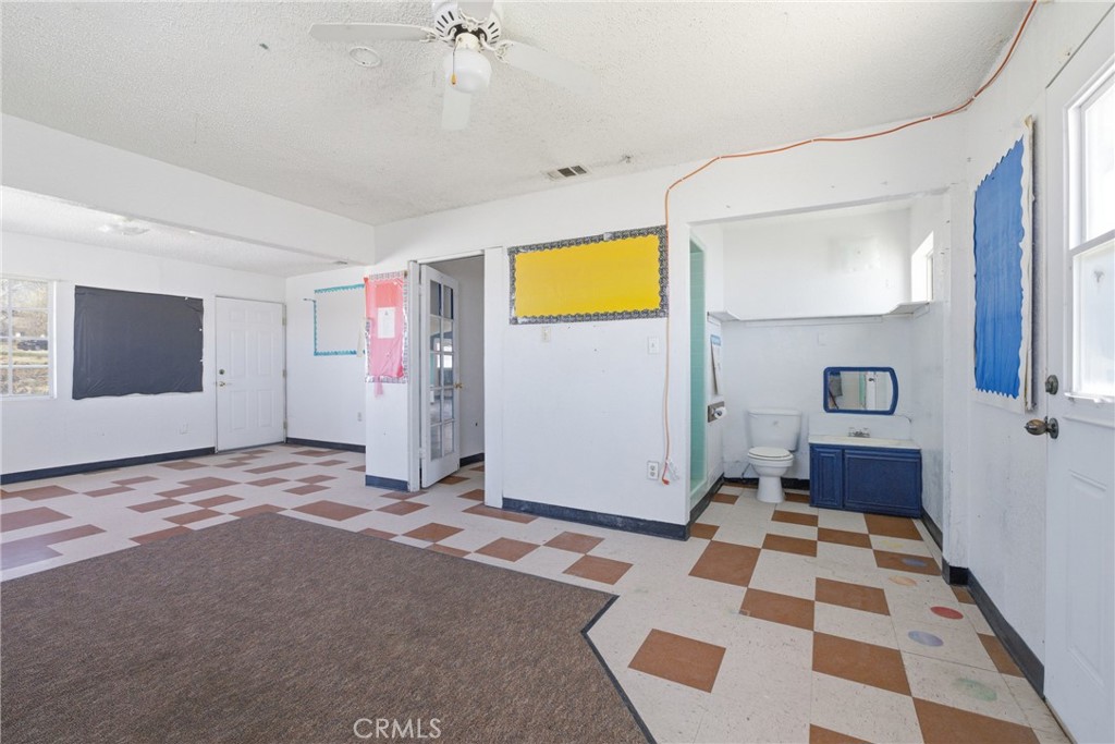 15637 Tuscola Road Apple Valley, CA 92307 - Photo 23 of 57 a view of a bedroom with a flesh and windows