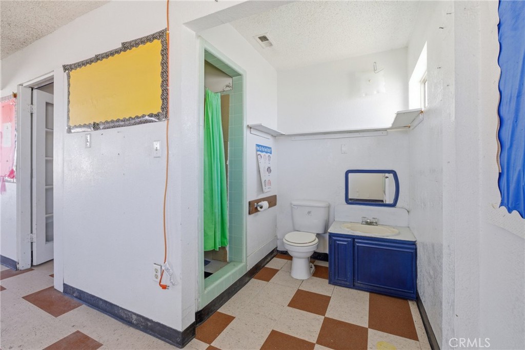 15637 Tuscola Road Apple Valley, CA 92307 - Photo 24 of 57 a bathroom with a toilet a sink and a mirror