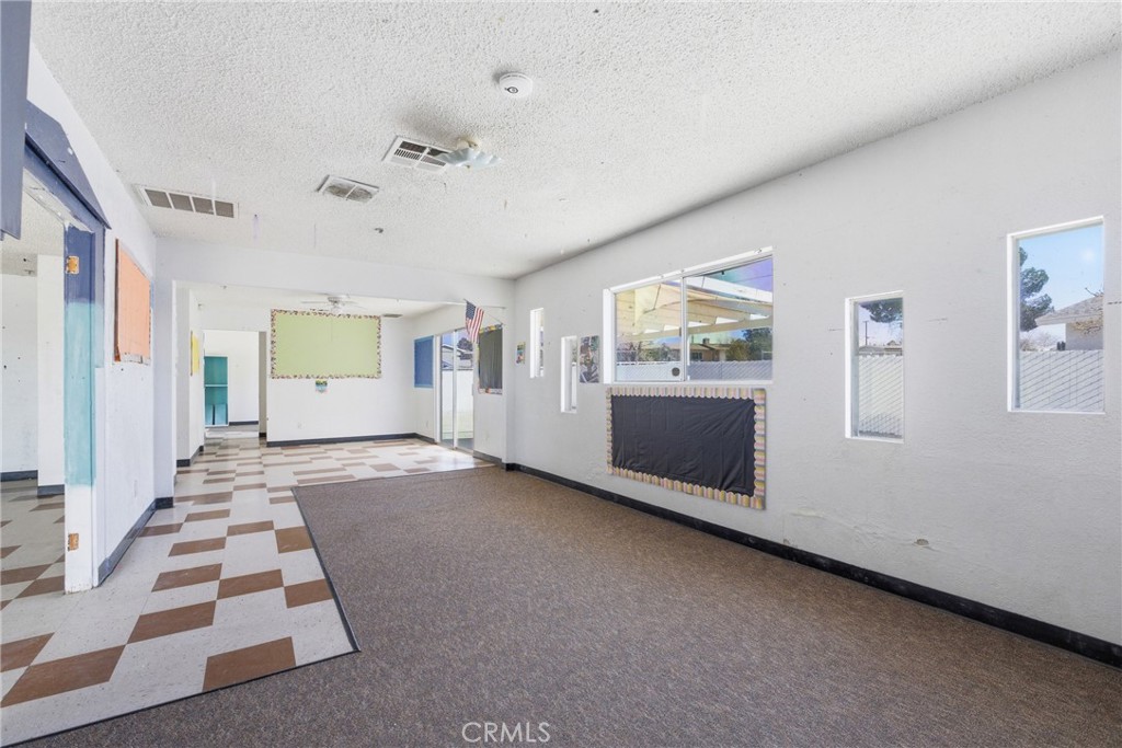 15637 Tuscola Road Apple Valley, CA 92307 - Photo 25 of 57 a view of a big room with windows and furniture