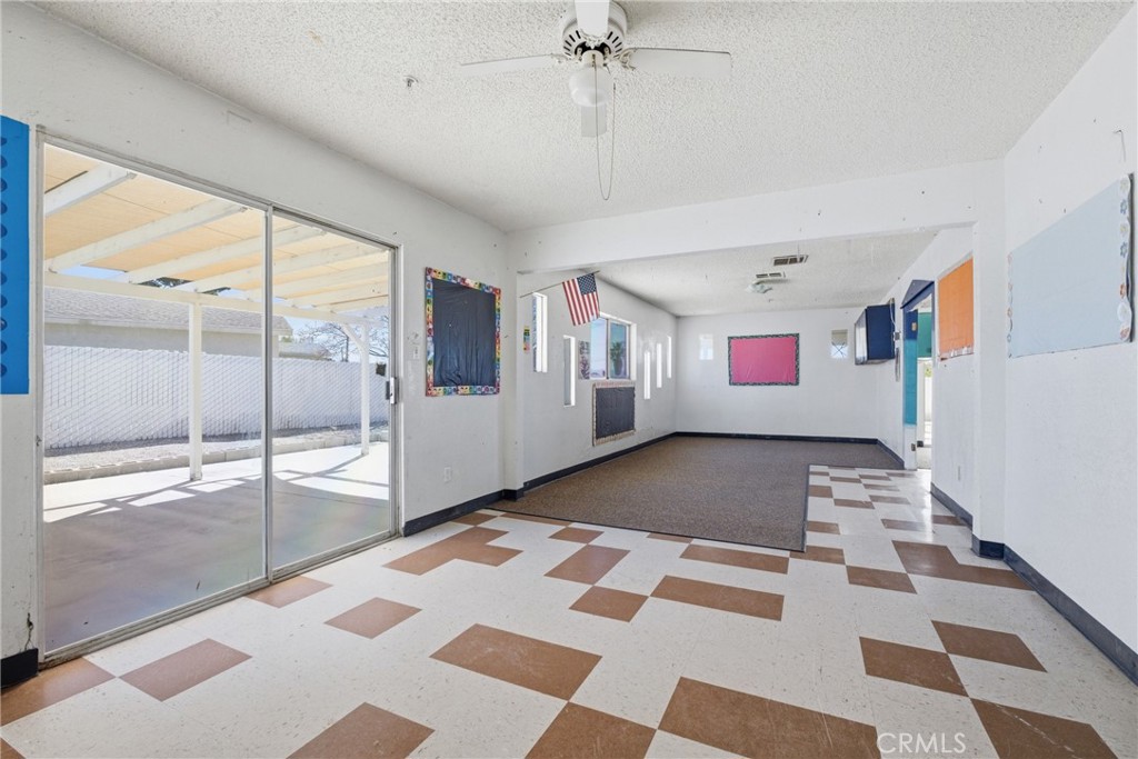 15637 Tuscola Road Apple Valley, CA 92307 - Photo 26 of 57 a view of a bedroom with wooden floor and windows