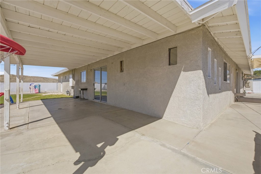15637 Tuscola Road Apple Valley, CA 92307 - Photo 36 of 57 a view of a patio with a tv