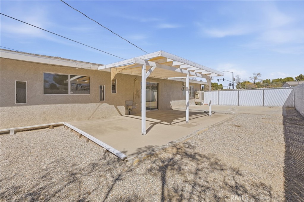 15637 Tuscola Road Apple Valley, CA 92307 - Photo 38 of 57 a patio with a table and chairs