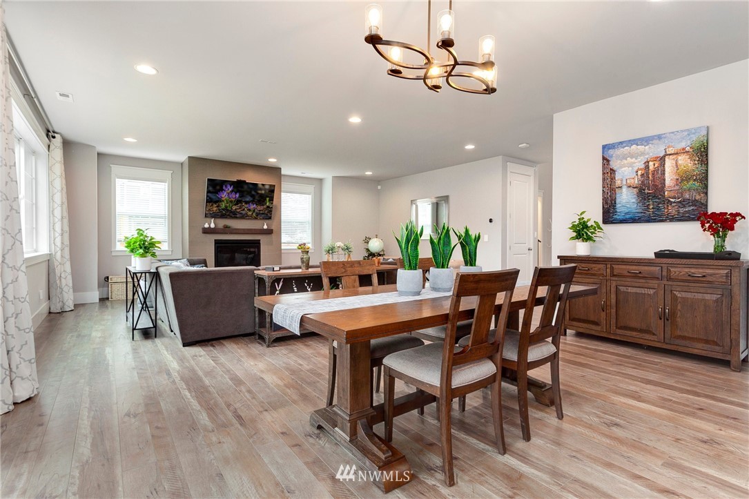 253 Field Place Southeast Renton, WA 98059 - Photo 14 of 40 a room with stainless steel appliances a dining table wooden floor and a view of kitchen