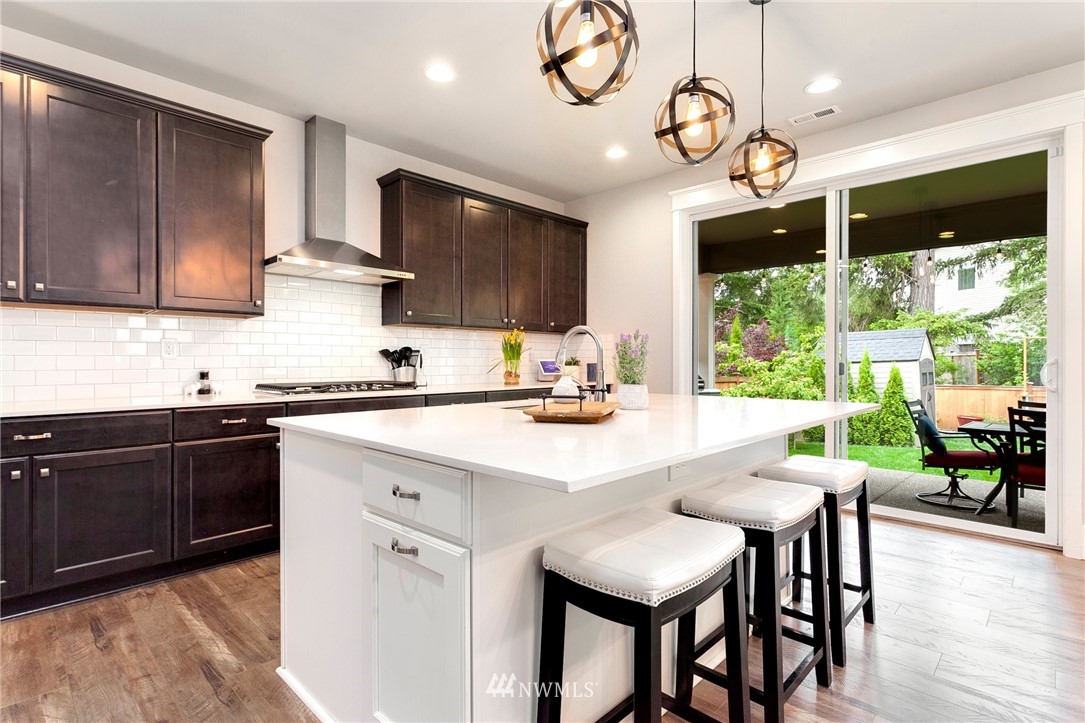 253 Field Place Southeast Renton, WA 98059 - Photo 15 of 40 a kitchen with a table chairs microwave and cabinets