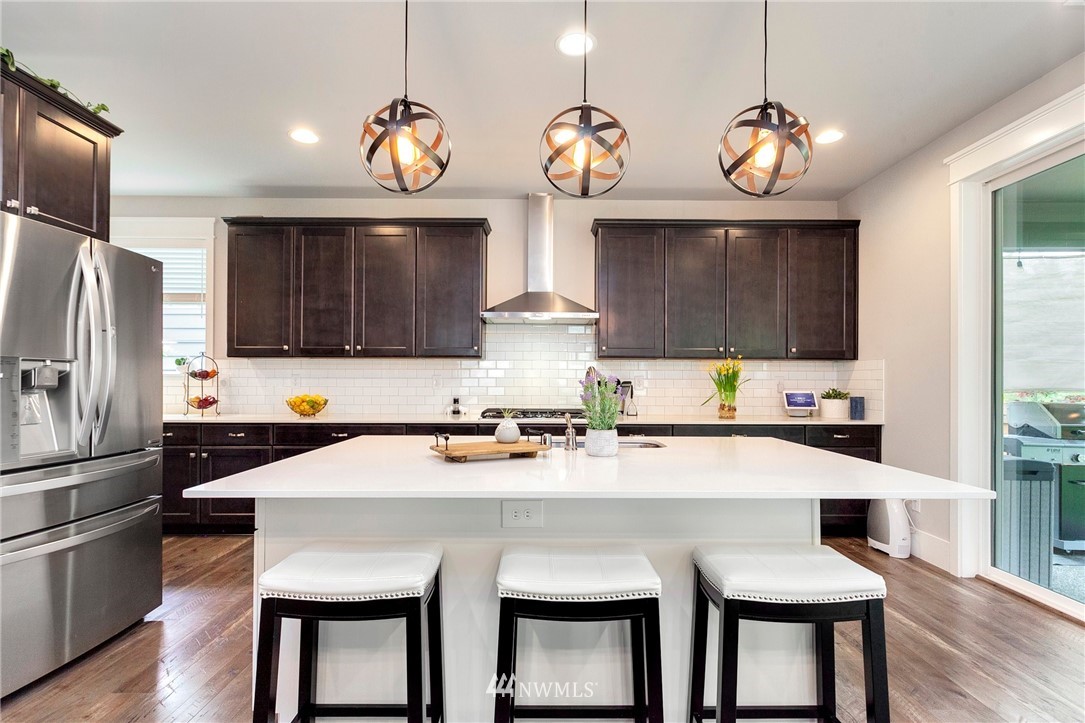 253 Field Place Southeast Renton, WA 98059 - Photo 17 of 40 a kitchen with stainless steel appliances a stove a sink refrigerator and cabinets